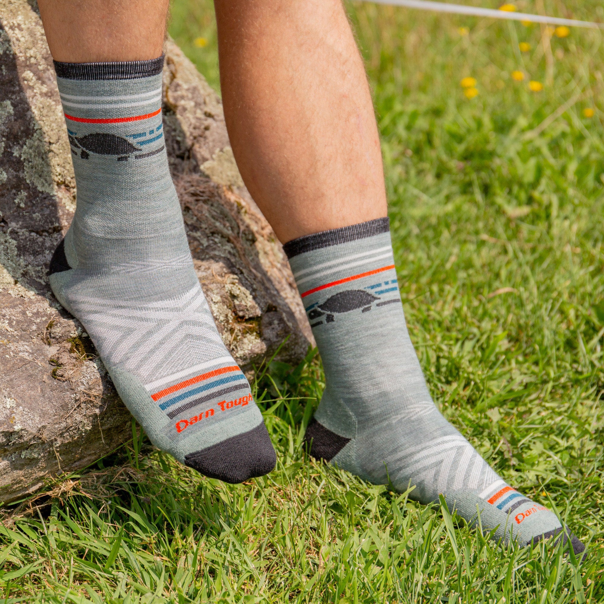 models feet one on grass on on rock wearing the 1041 pacer micro crew running sock in seafoam