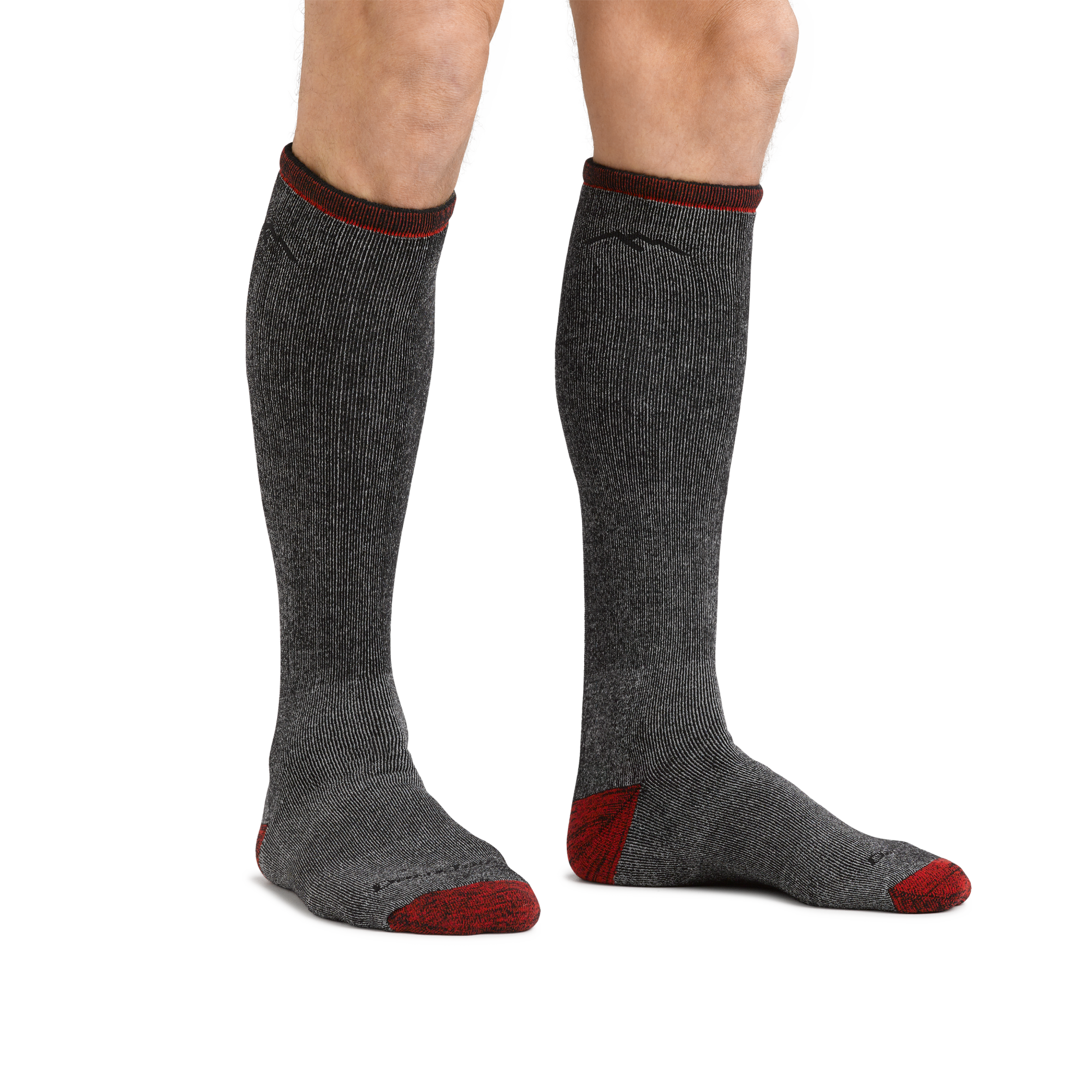 Man standing barefoot wearing Mountaineering Over the Calf Heavyweight Hiking Sock in Smoke
