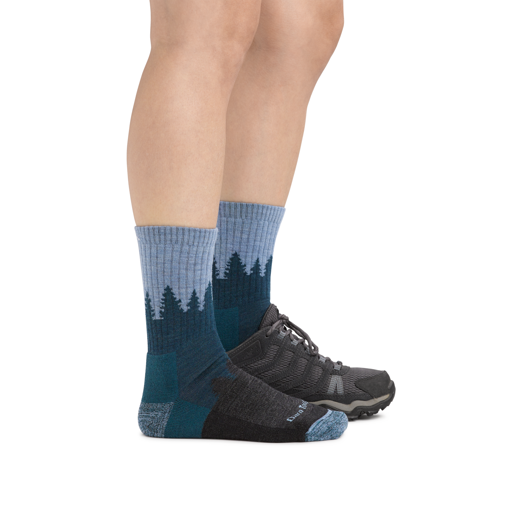 Woman wearing Women's Treeline Micro Crew Midweight Hiking Socks in Blue with one foot in a hiking boot