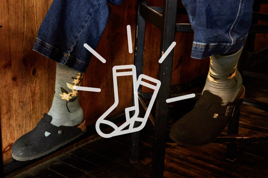 Shiny, happy socks icon over some sock-clad feet looking really comfy