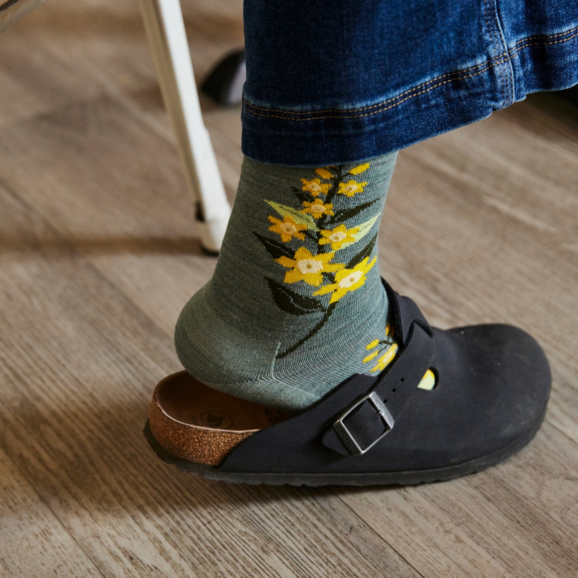 close up on model wearing clog and the 6401 Seafoam featuring green body and yellow flowers