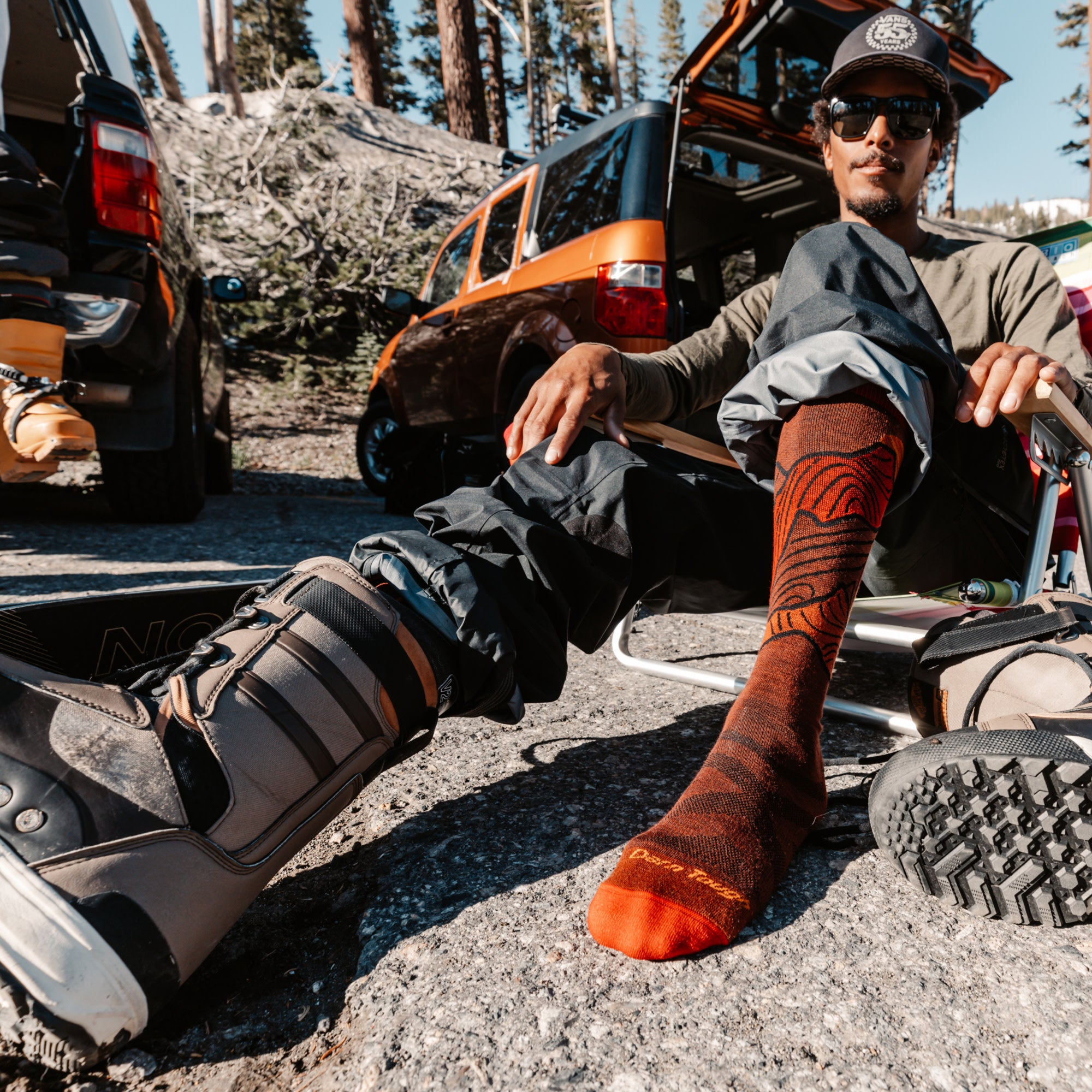 model sitting in chair with one boot on and 8050 fireball on other