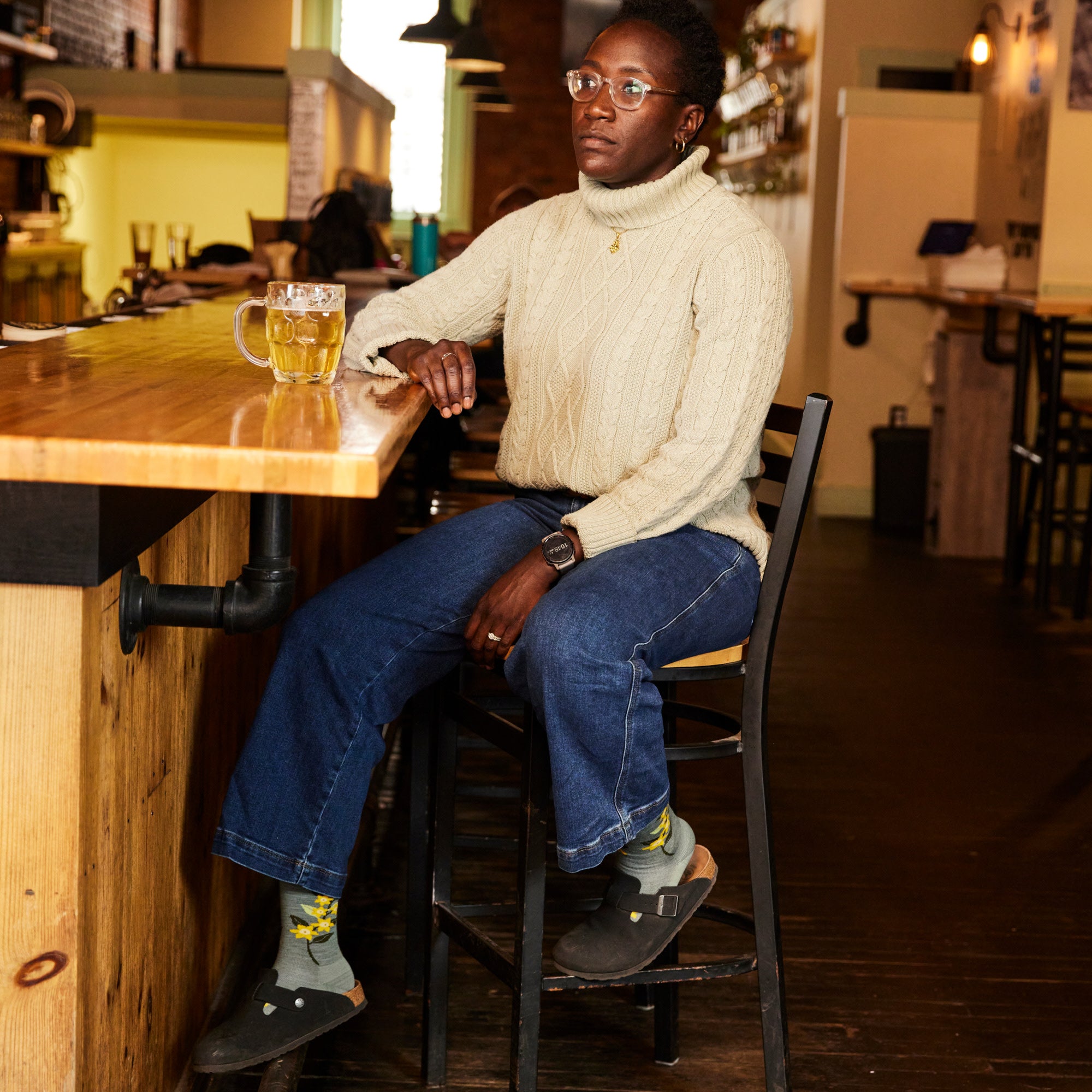 model sitting on bar stool wearing the 6104 Seafoam in clogs