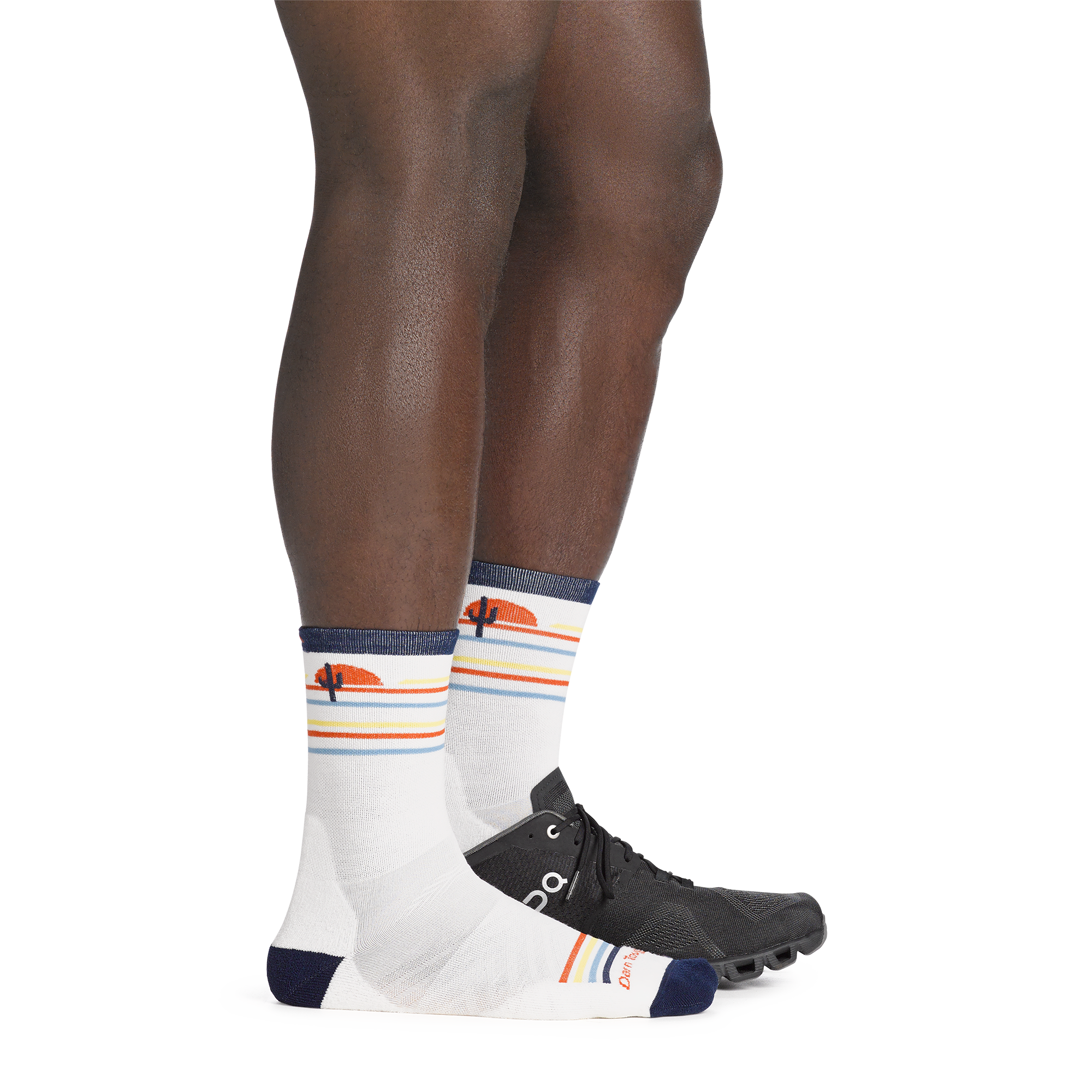 On model image back foot in sneaker, wearing the 1062 front runner micro crew running sock in white colorway.