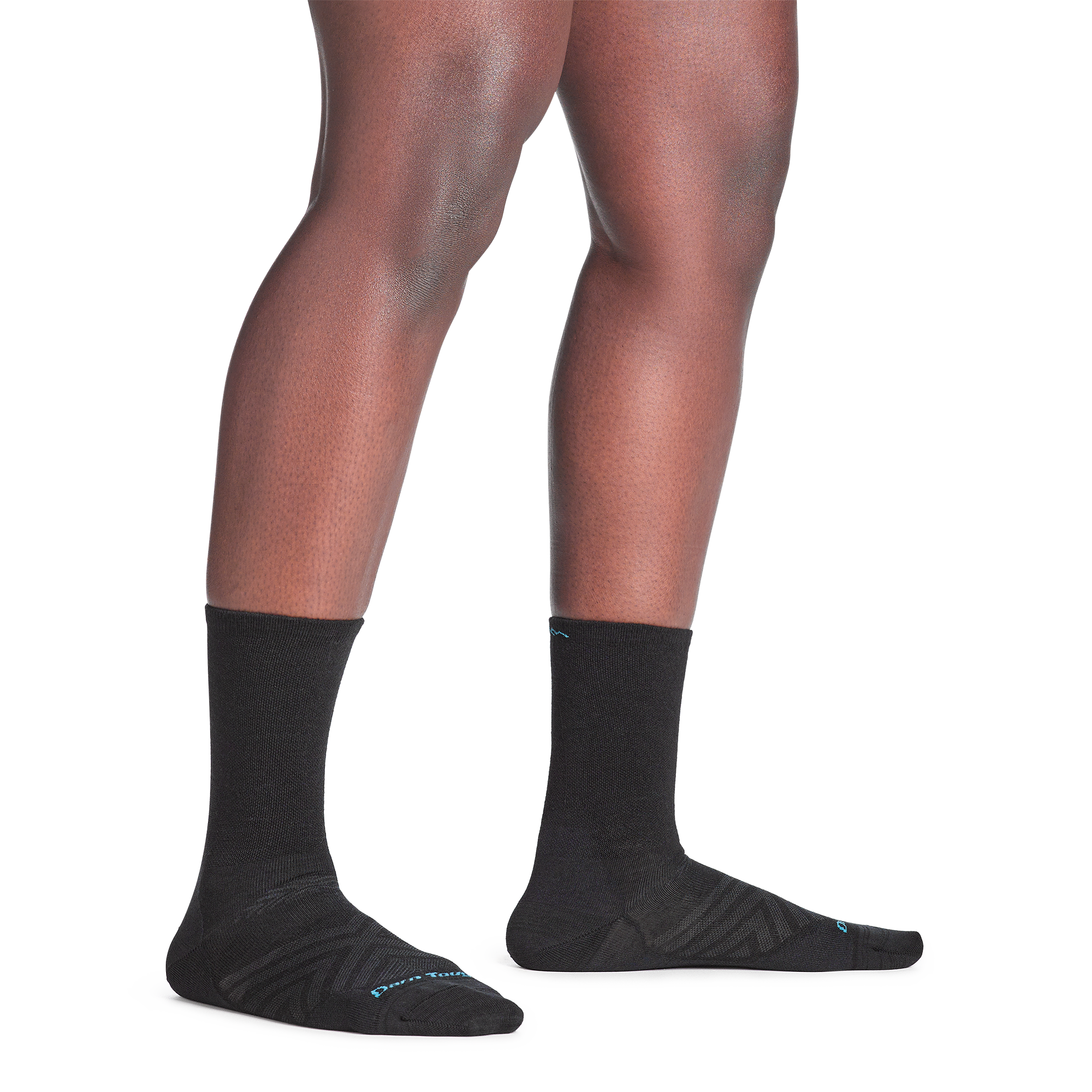 Model standing bare foot in 1068 micro crew running sock in black colorway