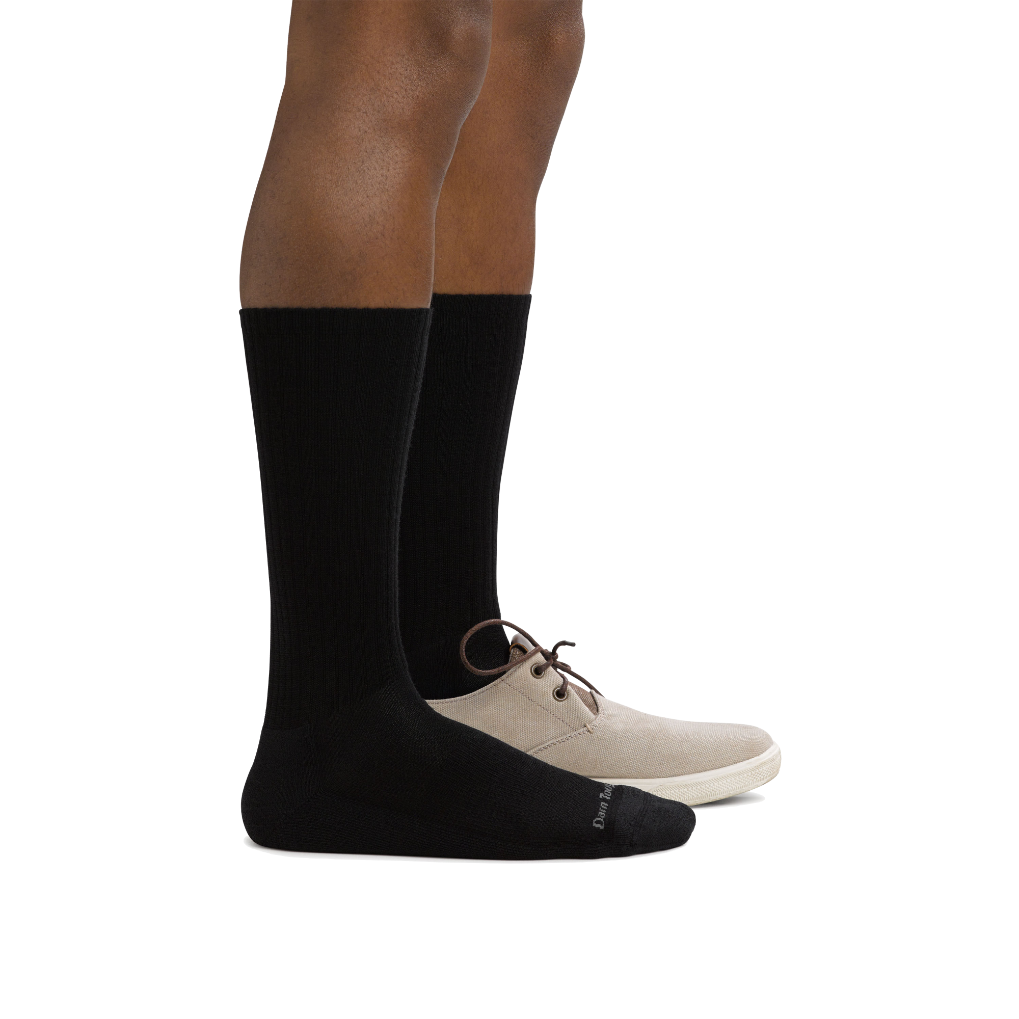Side shot of model wearing men's the standard crew lifestyle sock in black with a tan shoe on his left foot