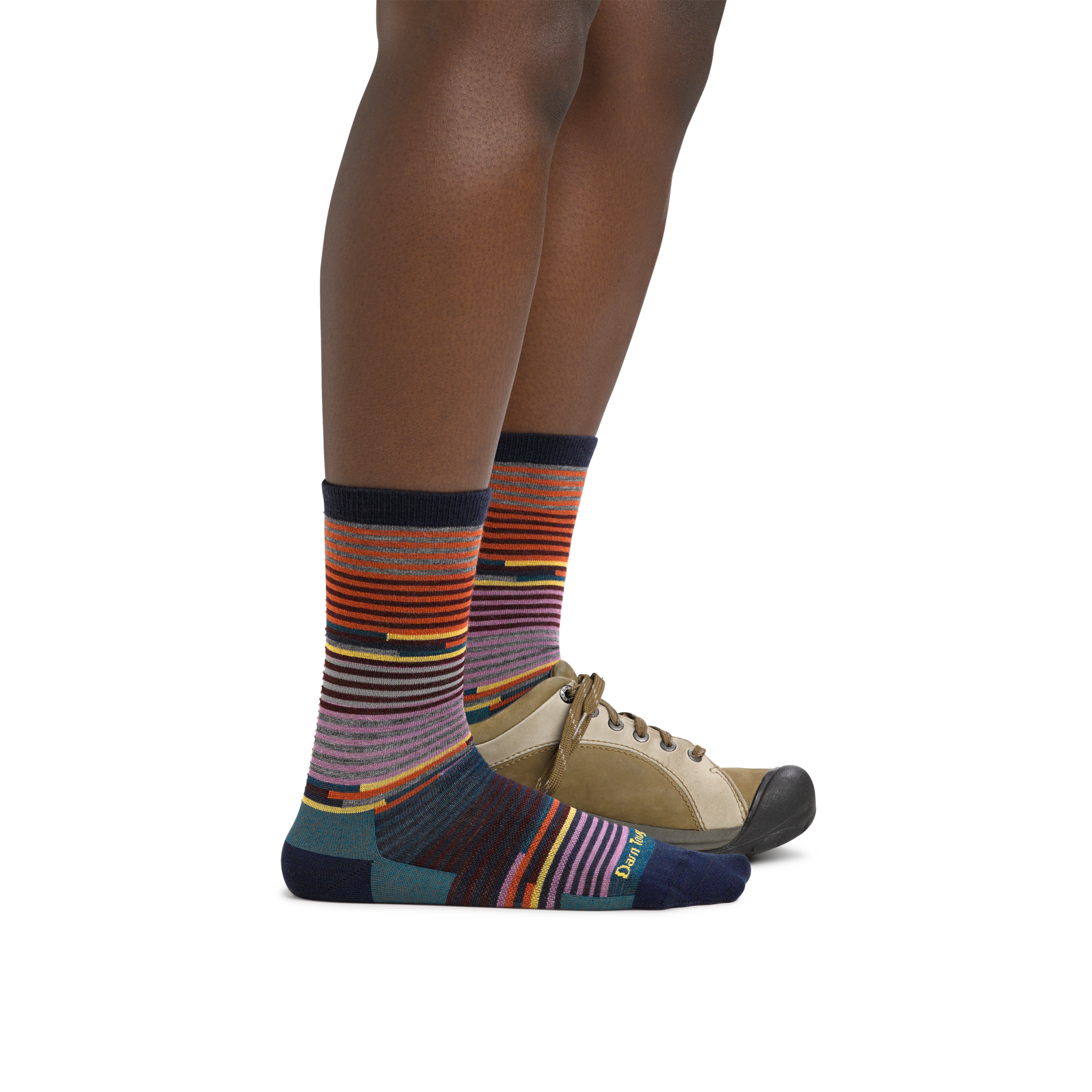 Woman wearing Women's Pixie Crew Lightweight Lifestyle Socks in Navy with one foot in a casual shoe
