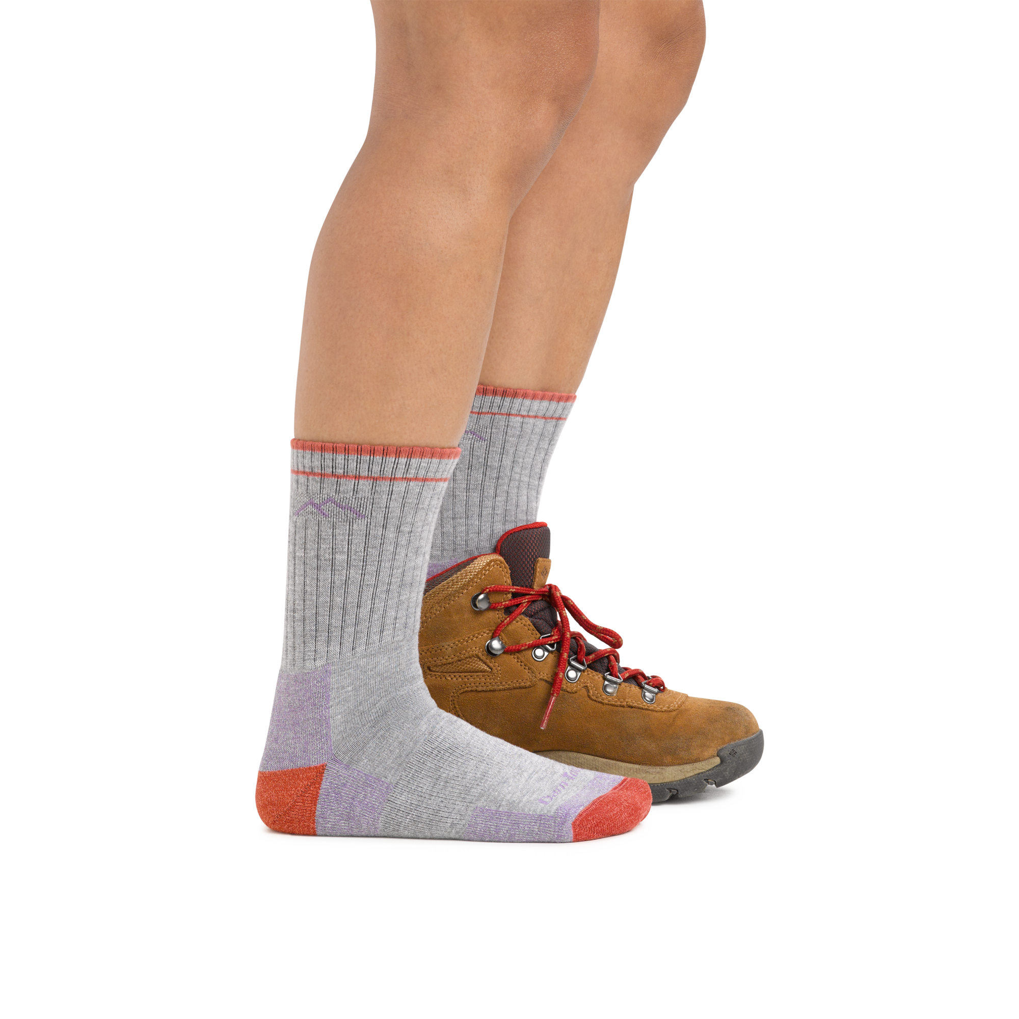 Woman wearing Coolmax Hiker Micro Crew Midweight Hiking Socks in Light Gray with one hiking boot on the back foot