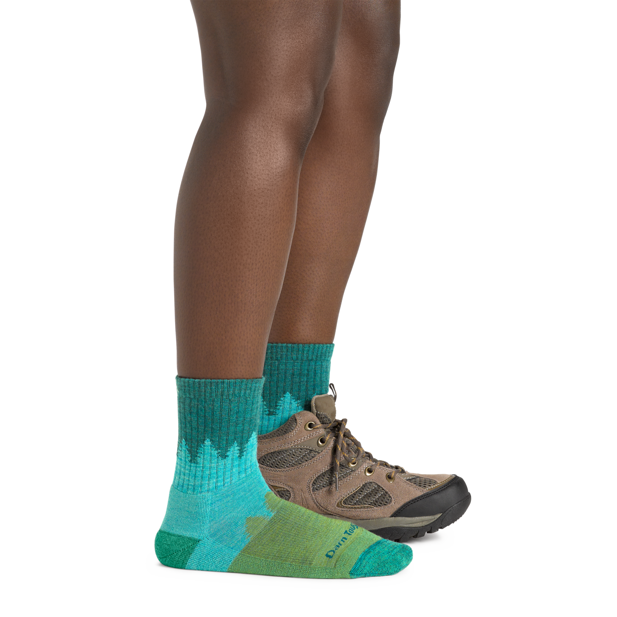 Profile image of a woman's legs on a white background wearing Women's Treeline Micro Crew Midweight Hiking Socks in Aqua with one foot in a hiking boot