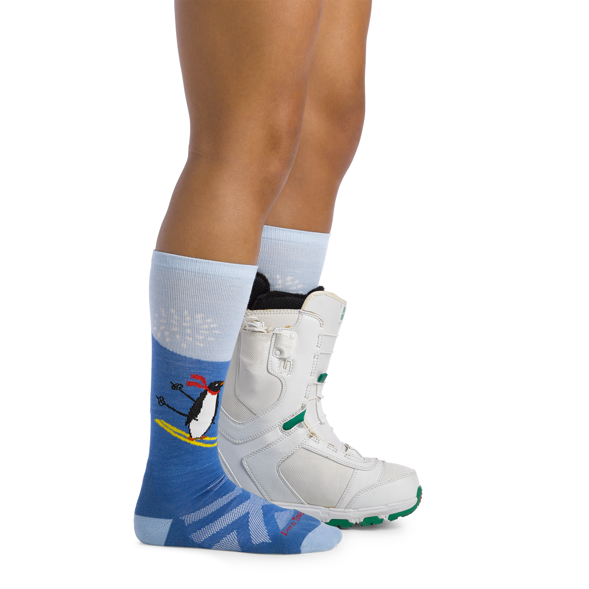 Image of model wearing 3808 Kids penguin peak ski and snowboard socks and a snow boot on one foot