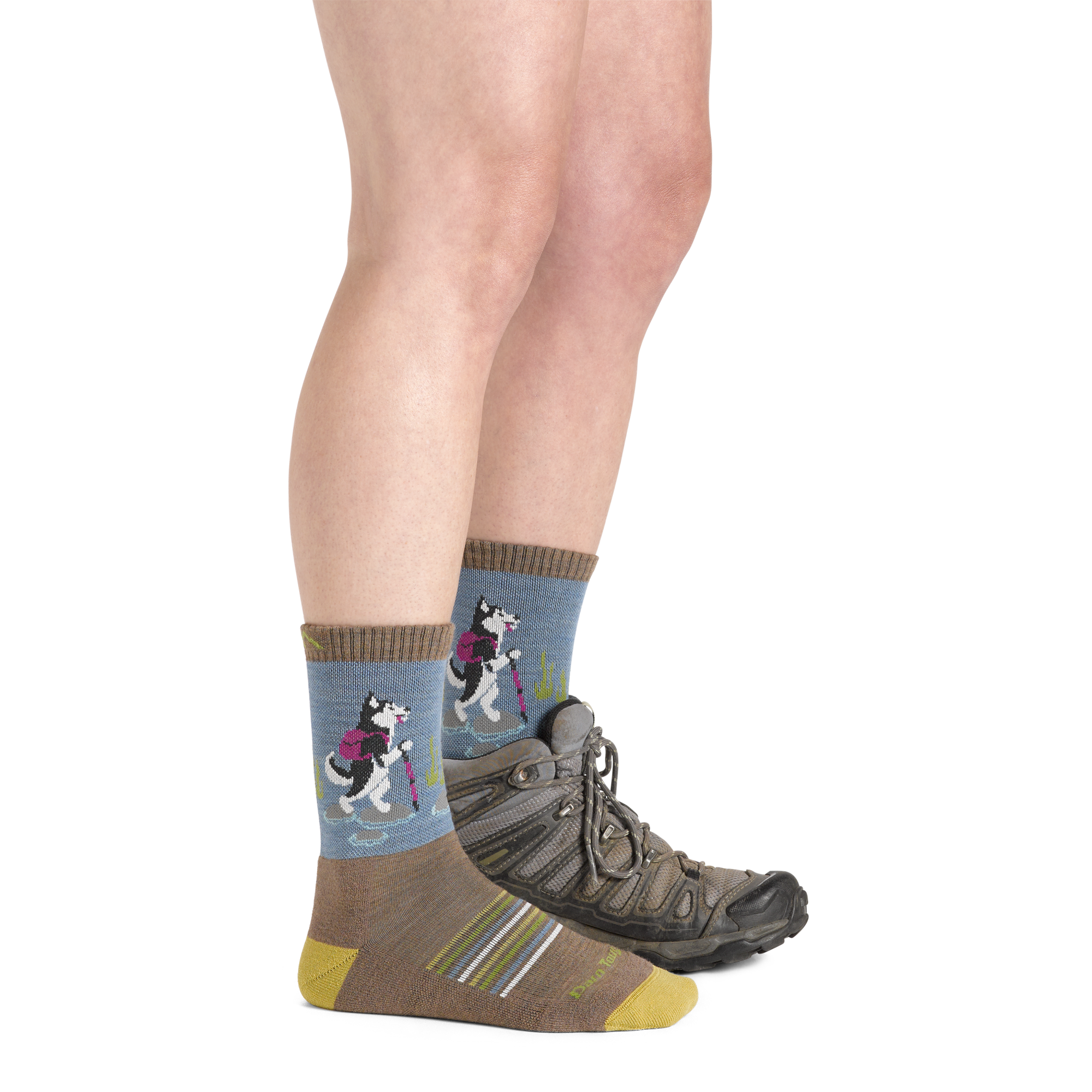 Side shot of model wearing the women's critter club micro crew hiking sock in bark colorway with a brown boot on her left foot