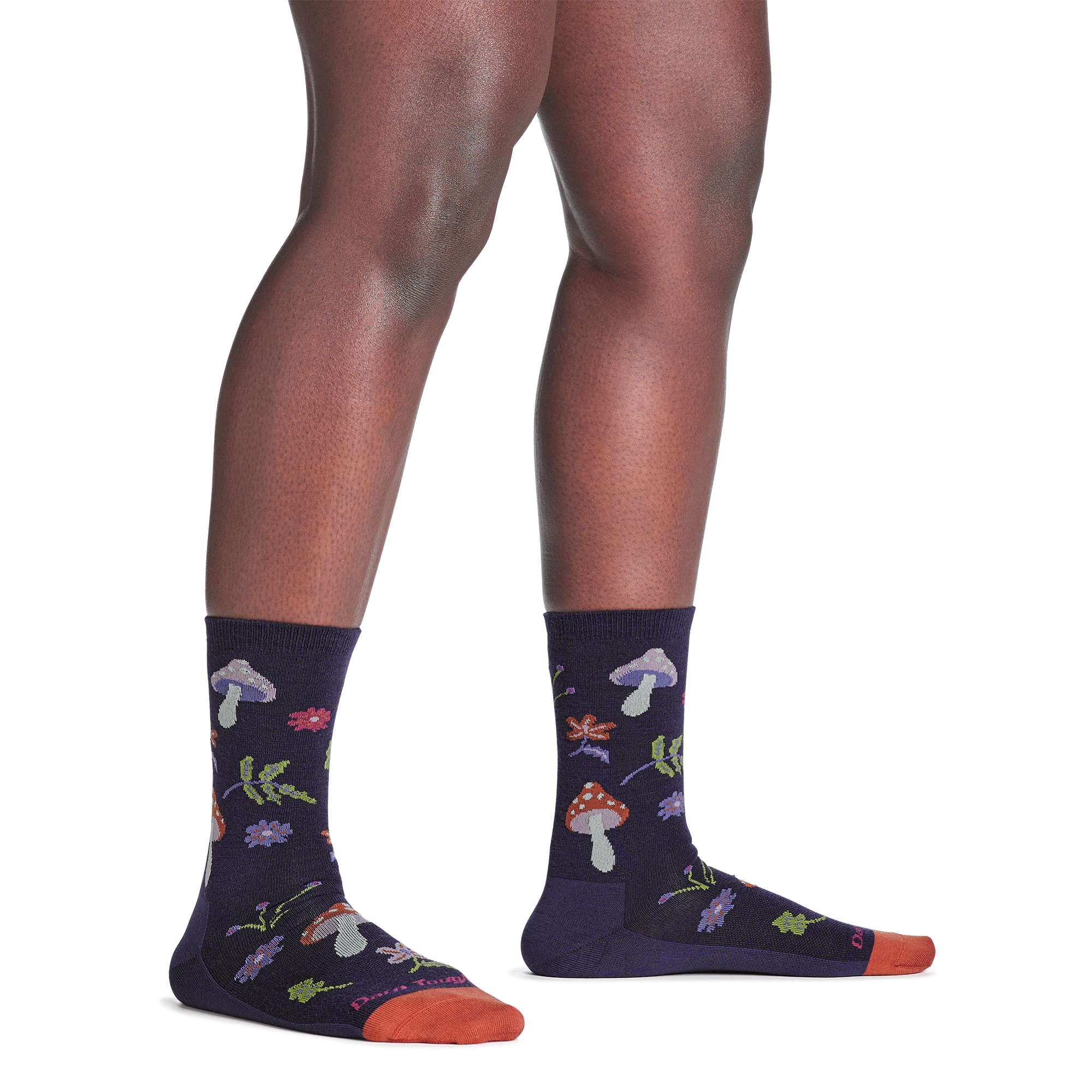 model standing barefoot wearing the 6133 shroom bloom lifestyle crew sock in blackberry colorway