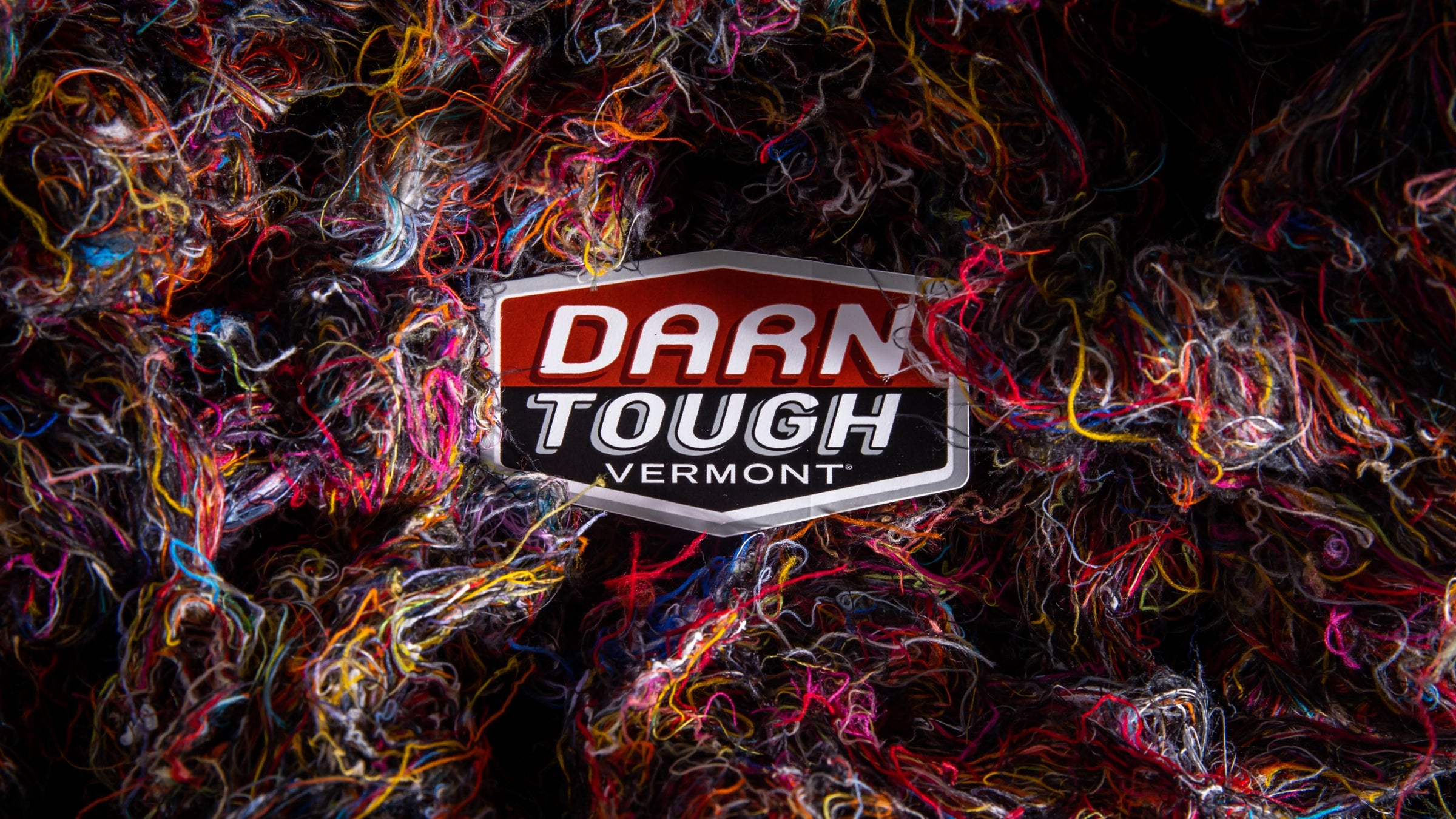 Darn Tough logo among Merino Wool fibers from making merino wool socks