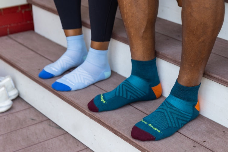 Shop Running Socks - Two pairs of feet wearing blue running socks