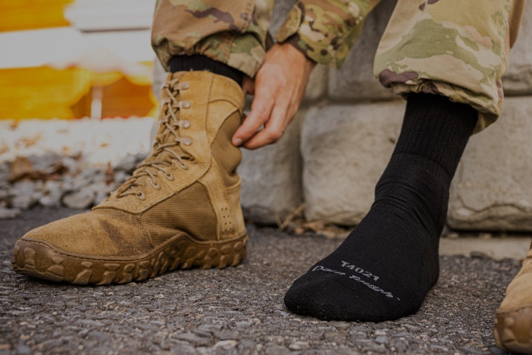 Shop Tactical Socks - feet wearing military boots and black socks