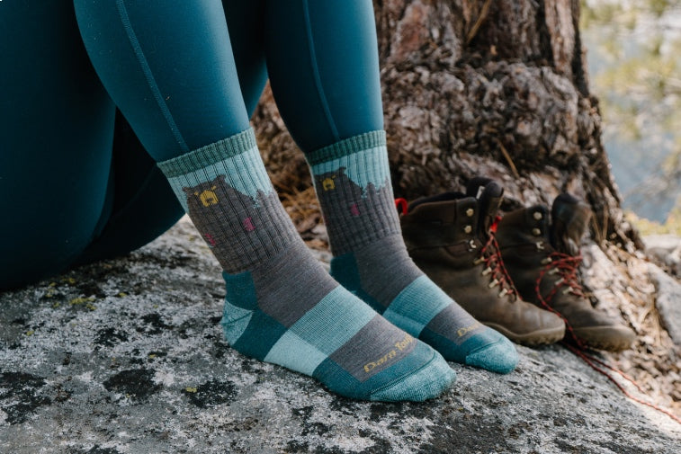 Shop gifts for her - feet wearing women's hiking socks with a bear on them