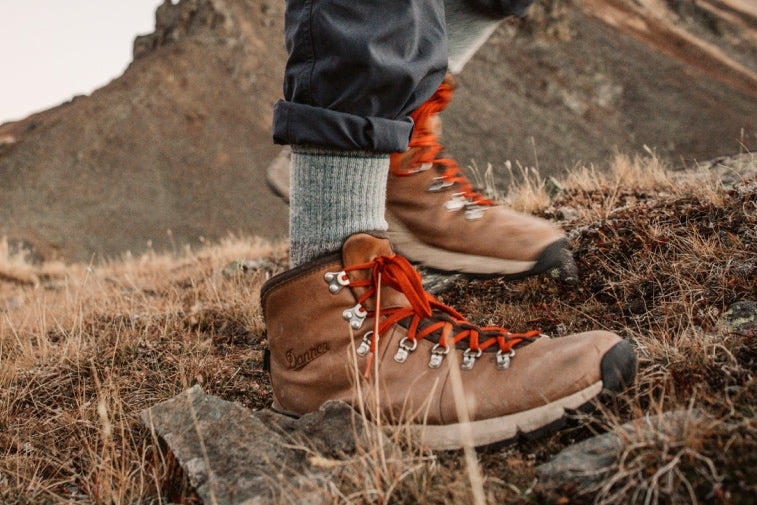 Shop Heavyweight Socks - feet wearing hiking boots and heavyweight merino wool socks on a cold day